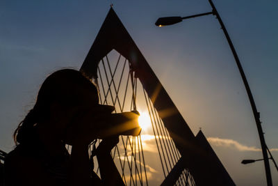 Low angle view of silhouette people at sunset