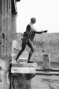 Full length of man on wall against building