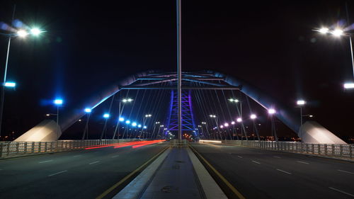 View of illuminated street lights at night