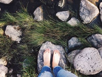 Low section of woman standing on rock