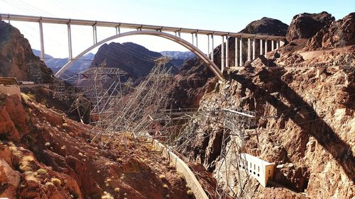 Arch bridge over river against sky