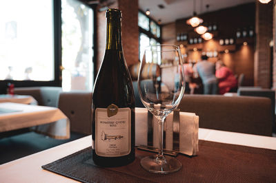 Glass of wine bottles on table at restaurant