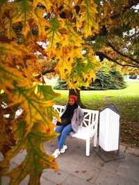 Full length of woman sitting in park