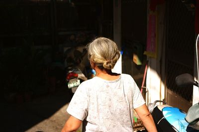 Rear view of senior woman walking on street