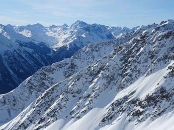 Scenic view of snow covered mountains against sky