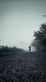 Silhouette man standing on field against clear sky