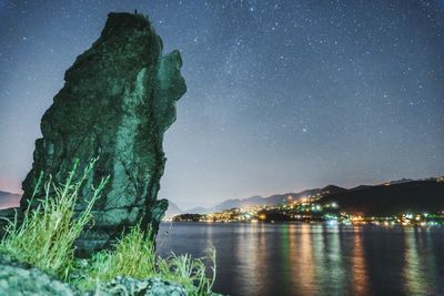 Scenic view of illuminated mountains against sky at night