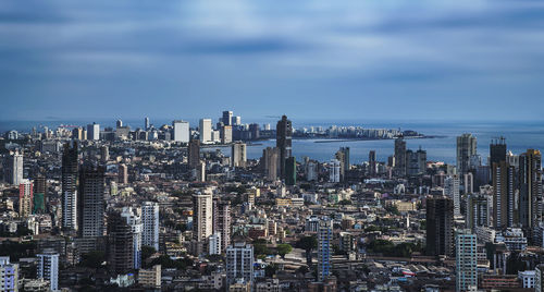 Aerial view of modern buildings in city against sky