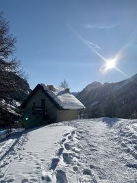 Scenic view of snow covered houses against sky