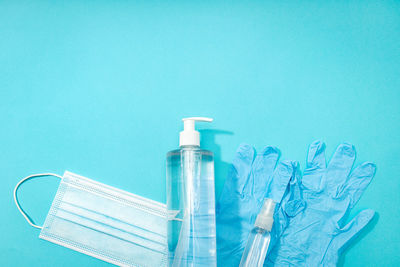 Close-up of glass bottle against blue background