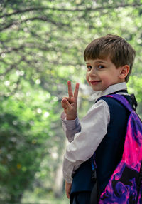 Portrait of smiling boy standing outdoors