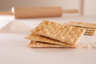 Close-up of cracker biscuit with ingredients on kitchen counter