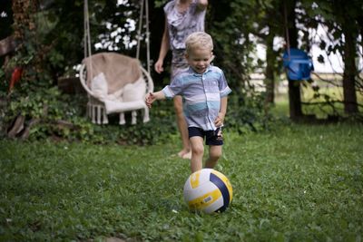 Boy playing soccer on field