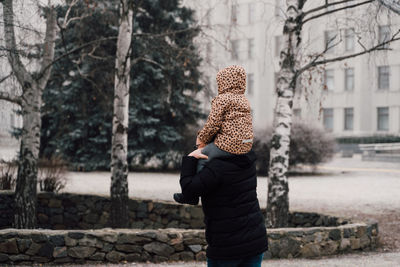 Father playing with child outdoors. happy parenting, family bond