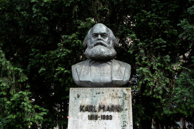 Statue against trees and plants