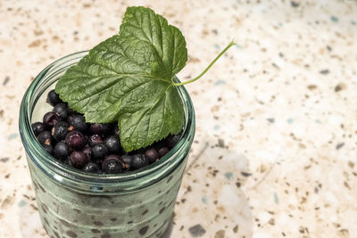 High angle view of berries in jar on table