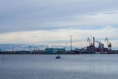 Commercial dock by sea against sky