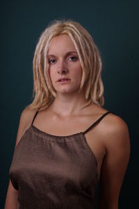 Portrait of a beautiful young woman over black background