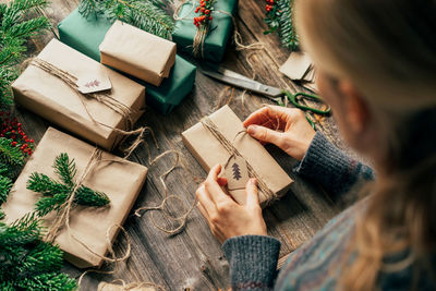 Woman wraps gifts for advent. christmas eve and crafting decorating. new year celebration.