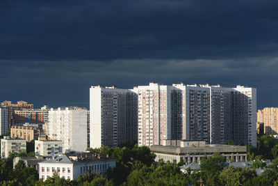 City buildings, dark clouds sky