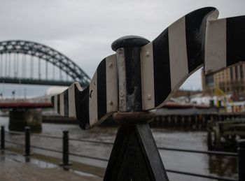 Close-up of bridge over river against sky