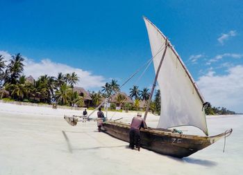 People on beach against sky