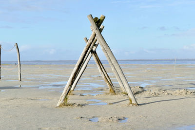 Lifeguard hut on beach against sky