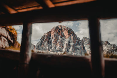 Panoramic view of mountains against sky seen through window