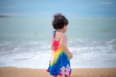 Full length of girl standing on beach