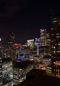 High angle view of illuminated buildings against sky at night