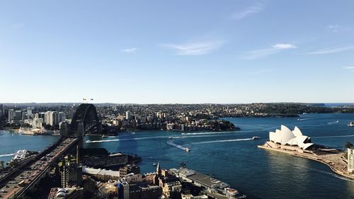High angle view of buildings by sea against sky