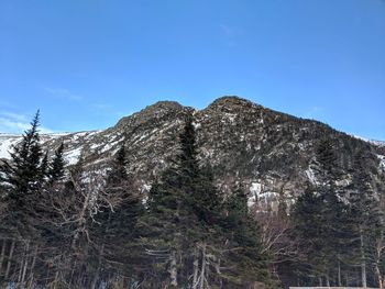 Low angle view of mountain against blue sky