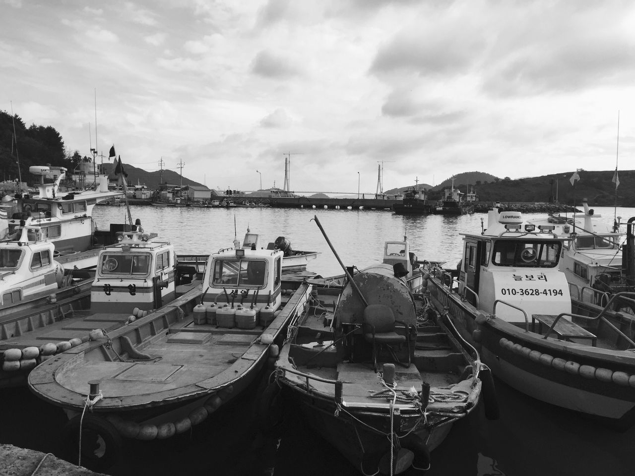 nautical vessel, moored, boat, transportation, mode of transport, sky, water, harbor, sea, cloud - sky, cloudy, building exterior, mast, built structure, cloud, architecture, day, marina, outdoors, sailboat