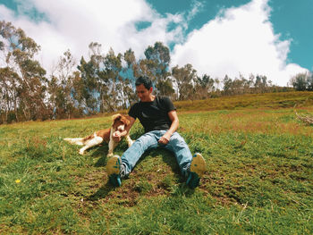 Young couple sitting on field