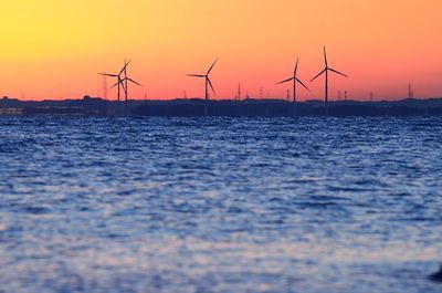 Calm sea with wind turbines in distance