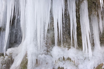 Panoramic shot of frozen waterfall in forest