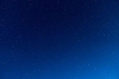 Low angle view of stars against clear blue sky