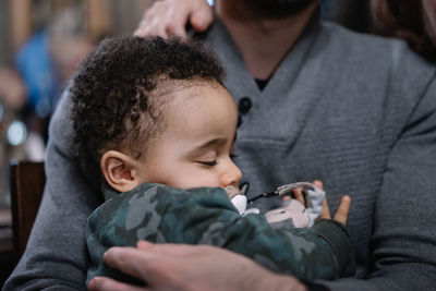 Close-up of man holding a baby 