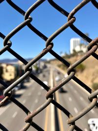 Close-up of chainlink fence against sky