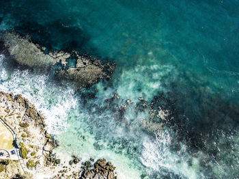 High angle view of rocks on sea shore