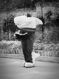 Rear view of man standing on road