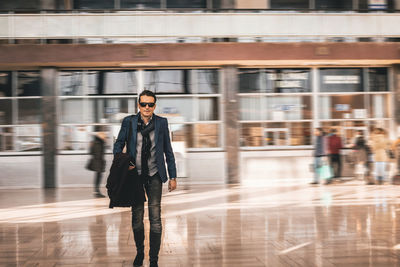 Portrait of businessman walking at airport
