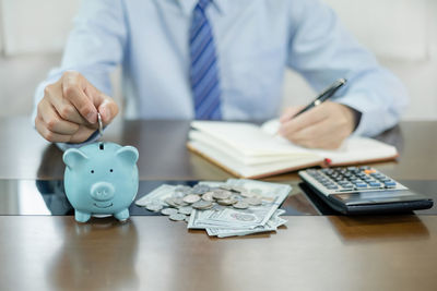 Midsection of doctor working on table