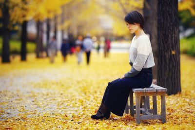 Side view of senior man sitting on seat in park