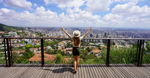 Full length of woman standing on footbridge