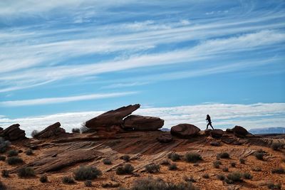 Scenic view of rocks on shore against sky