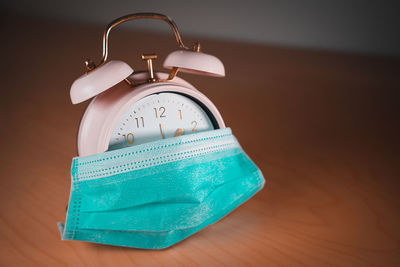 Close-up of clock on table at home