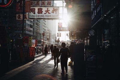 People in illuminated city at night