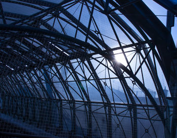 Low angle view of silhouette crane against sky