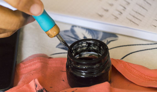 High angle view of human hand holding paper